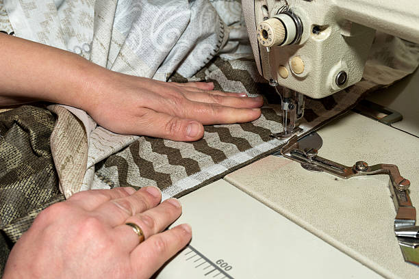 close up hands of seamstress working on sewing machine - copy spaceclose up hands of seamstress working on sewing machine - copy space
