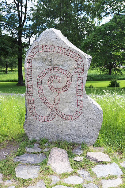 Runic inscriptions on a runestone Runic inscriptions on a runestone in Mariefred, Sweden mariefred stock pictures, royalty-free photos & images