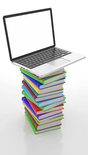 istock tower of books on top a laptop, education concept 512734570