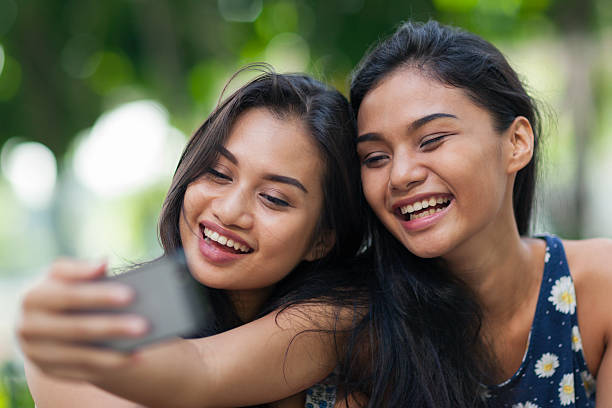 istock Two friends having fun taking a selfie 512734958