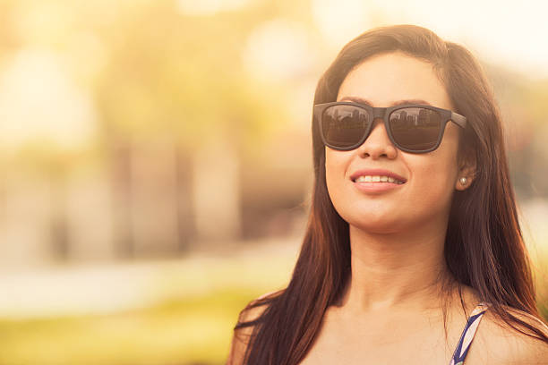 Sunny day A woman outdoors wearing shades on a summer day. hot filipina women stock pictures, royalty-free photos & images