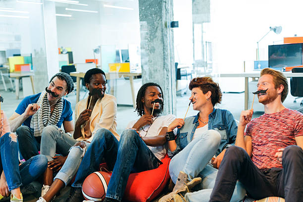 istock Multi-ethnic Young People Celebrating Movember In Their Office. 512736118