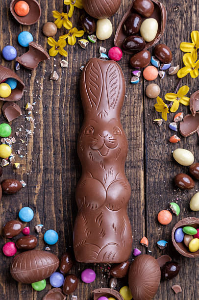 istock Chocolate easter eggs and sweets on wooden background 512739084