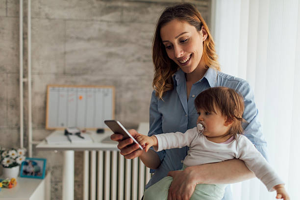 istock Mother Working from home and holding her baby 512740040