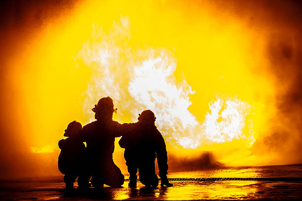 istock Firefighters in front of a burning tank 512740722