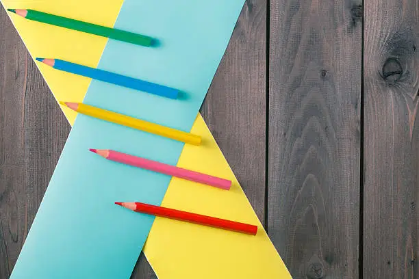 pencilee with crosser color band on rustic wooden table