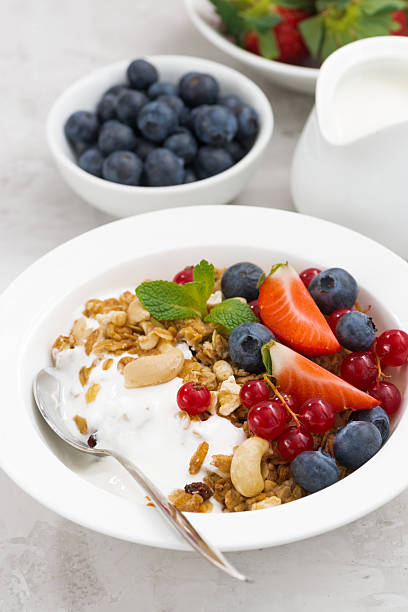 istock Baked muesli with fresh berries and yogurt, vertical 512743022