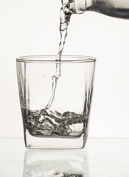 istock water pour from  bottle to glass 512743448