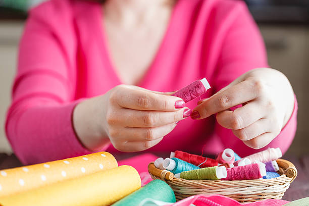 istock The woman is holding threads 512744626