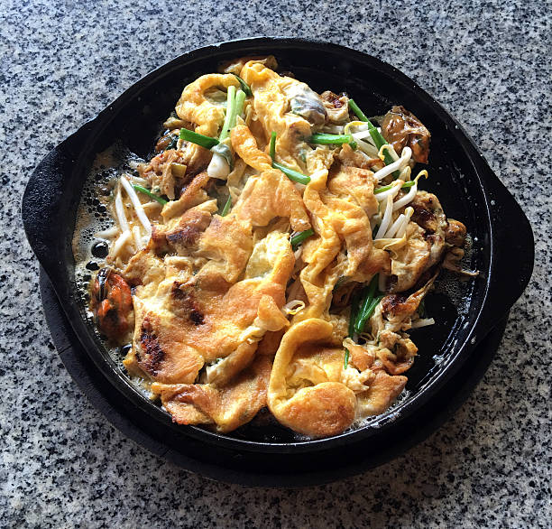 Oysters fried in egg batter Pan-fried crispy mussel with bean sprout Crispy Mussel and Beansprout Pancake Thai food