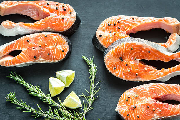 Raw trout steaks on the wooden board Raw trout steaks on the wooden board omega 3 and 6 stock pictures, royalty-free photos & images