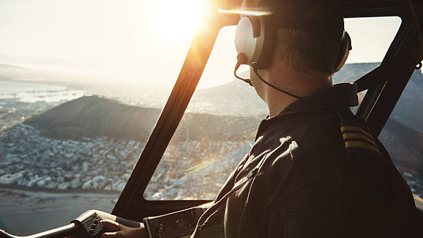 istock Pilot flying a helicopter and looking outside the window 512747988