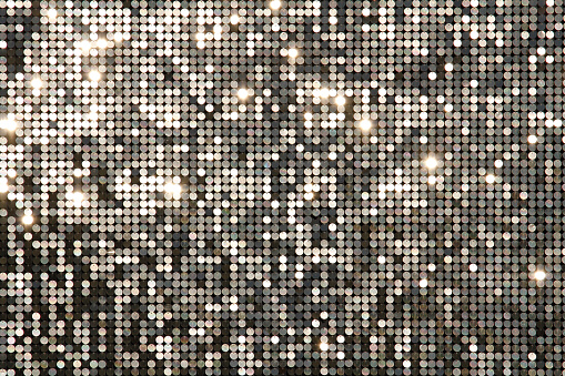 Copy space shot of a gold and silver colored sparkly tinsel curtain backdrop for New Year's eve party celebration.