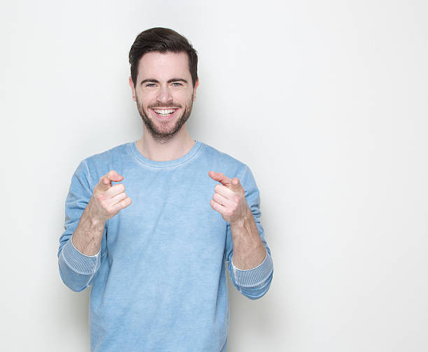 istock Happy young man pointing fingers 512750315