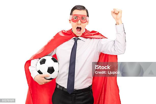 Superhero Cheering And Holding A Football Stock Photo - Download Image Now - Superhero, Adults Only, Cape - Garment