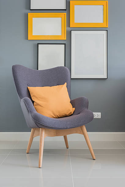 istock modern wooden chair with orange pillow 512755388