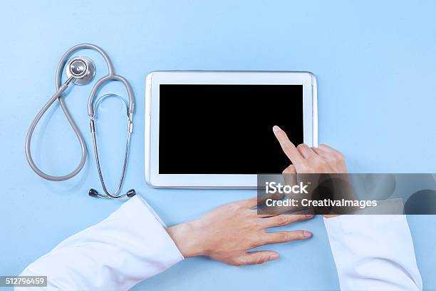 Doctor Working On A Digital Tablet Stock Photo - Download Image Now - Adult, Blank, Business