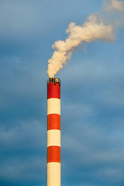 istock High chimney with smoke against polluted grey sky 512800833