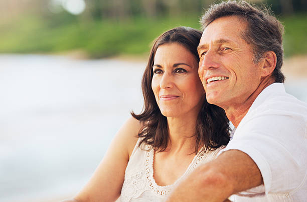 istock Mature Couple Enjoying Sunset on the Beach 512801213