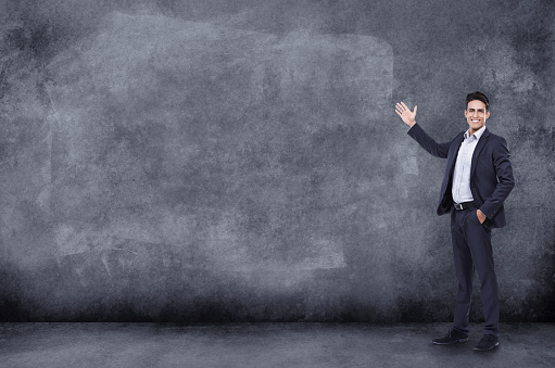 Shot of a handsome businessman standing in front of a large chalkboardhttp://195.154.178.81/DATA/i_collage/pi/shoots/784158.jpg