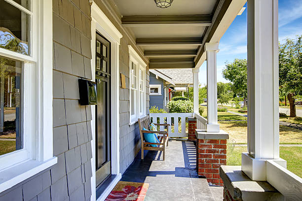 istock Large entance porch with brick trim and white railings 512801325