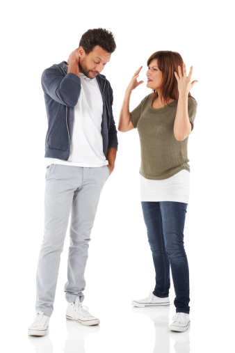 Full length portrait of mature couple having an argument over white background