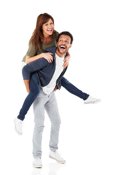 счастливый зрелый человек piggybacking его подруга - couple isolated heterosexual couple cheerful стоковые фото и изображения