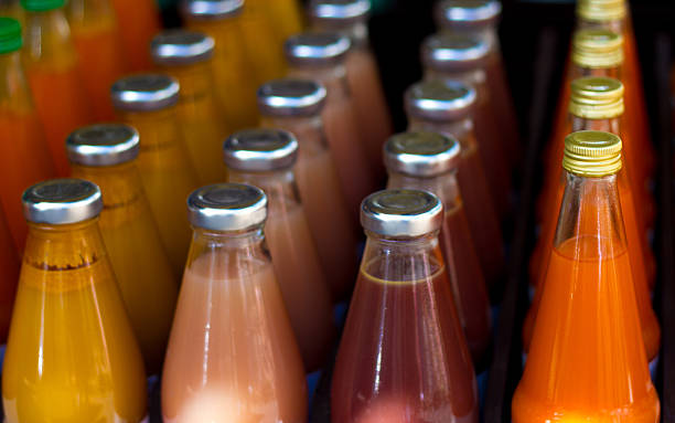 Colorful bottles of fruit juice in rows.