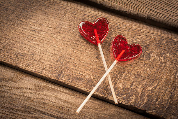 istock Love concept. Red hearts lollipops on wooden background 512802162