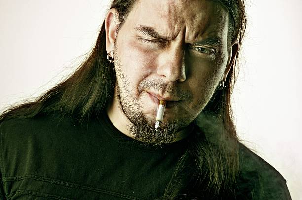 Rocker man smoking stock photo