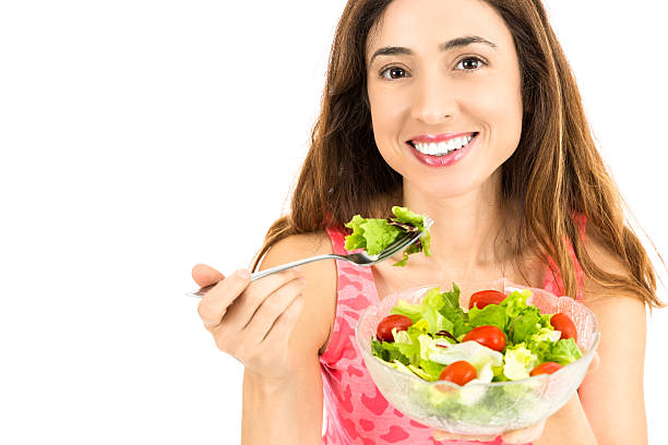 istock Smiling woman eating salad 512803574