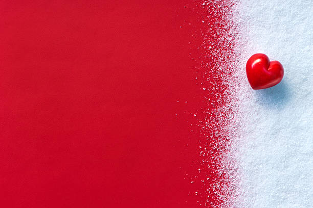 istock Red stone heart on white snow winter 512805254