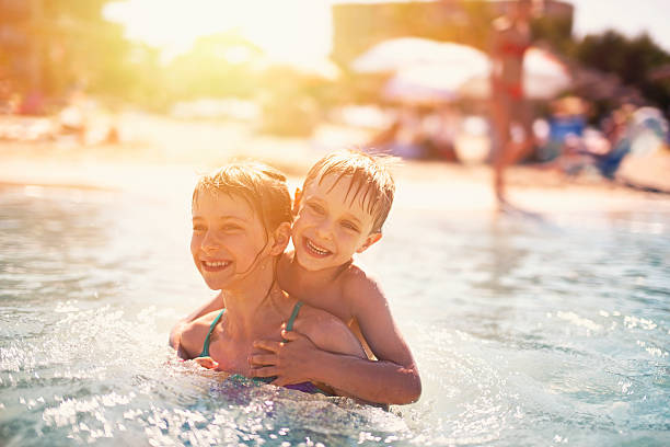 istock Brother and sister having fun playing in sea 512808008