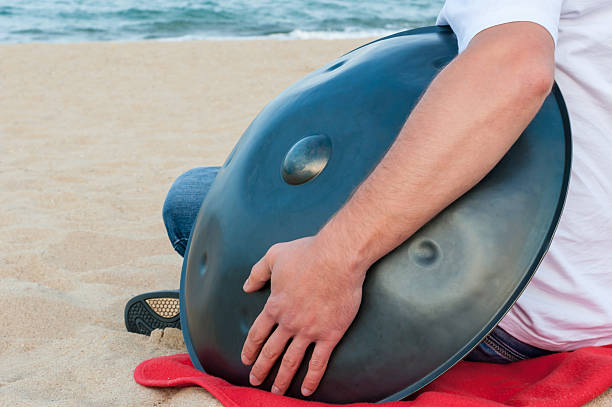 istock Relax music background. Hands percussion. Musician sit on sand and 512810654