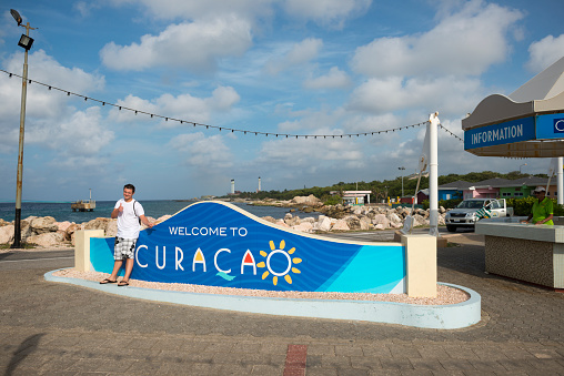 Willemstad, Curacao - September 30, 2014: A cruise ship passenger poses for a photo after disembarking a cruise ship visiting Willemstad, Curacao.