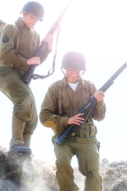 istock Two Soldiers Walk Down a Steep Hill in Bright Sun 512810830