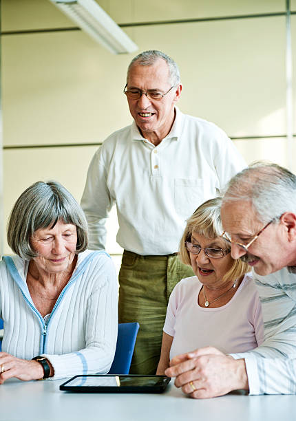istock Group of senior adult having fun with digital tablet 512812712