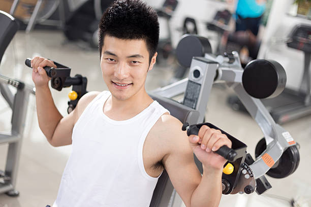 istock young handsome man working out in modern gym 512813172