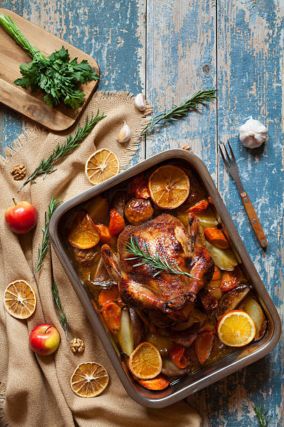 istock Homemade roasted chicken with vegetables and herbs in baking dish 512813266