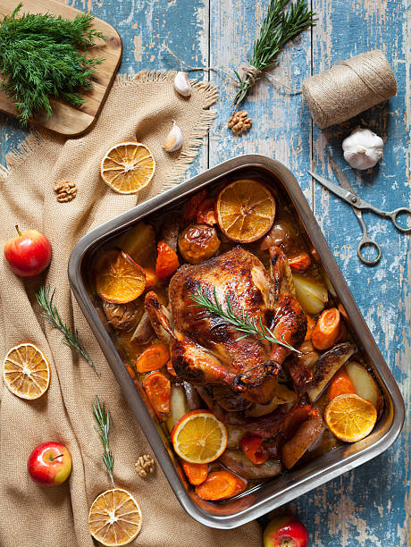 istock Barbecued chicken with various vegetables and garlic in baking dish. 512813412