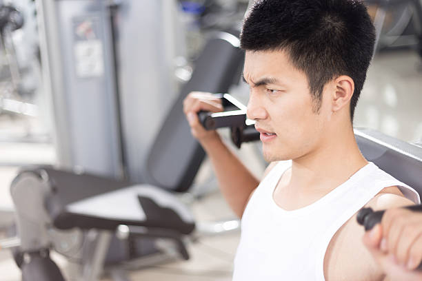 istock young handsome man working out in modern gym 512813872