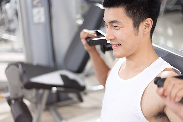 istock young handsome man working out in modern gym 512814026