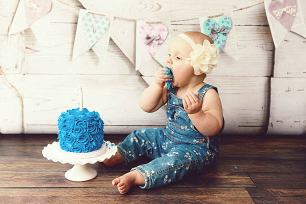 istock Baby Girl Eating Birthday Cake 512814364