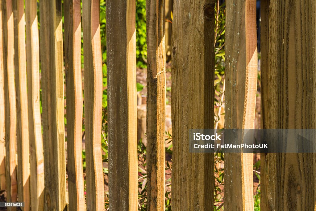 Close up of wooden fence, wood vertical slats. Vertical rough-hewn planks of wood, part of fence. Boundary Stock Photo