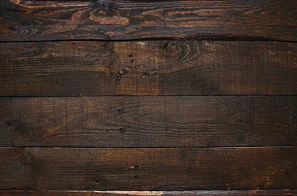 Photo of Dark brown rustic  aged barn wood planks background