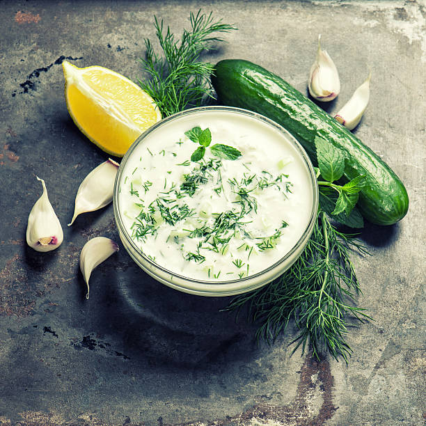 istock Fresh tzatziki yogurt sauce. Herbs vegetables vintage 512817744