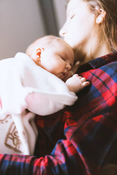 istock Newborn baby lying on her mother's chest 512818018