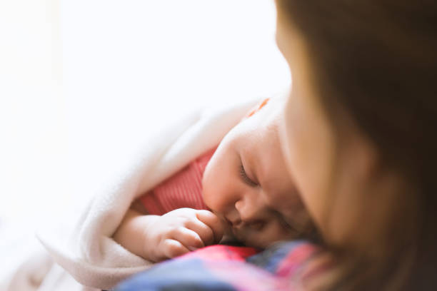 istock Newborn baby lying on her mother's chest 512818546
