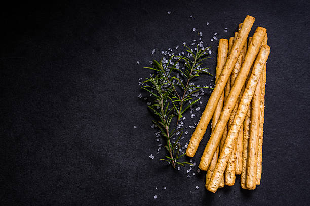 Crispy breadsticks with salt and fresh rosemary stock photo