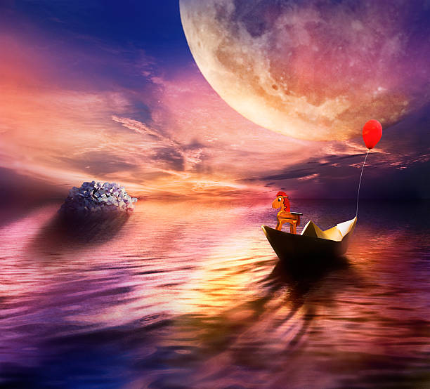 istock paper boat at sunset 512818738